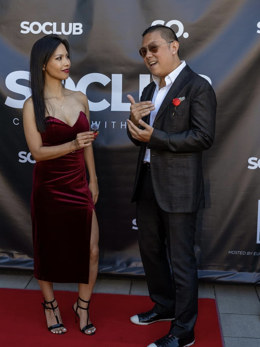 Rachel Dragas interviewing a guest on the red carpet at the SOCLUB event