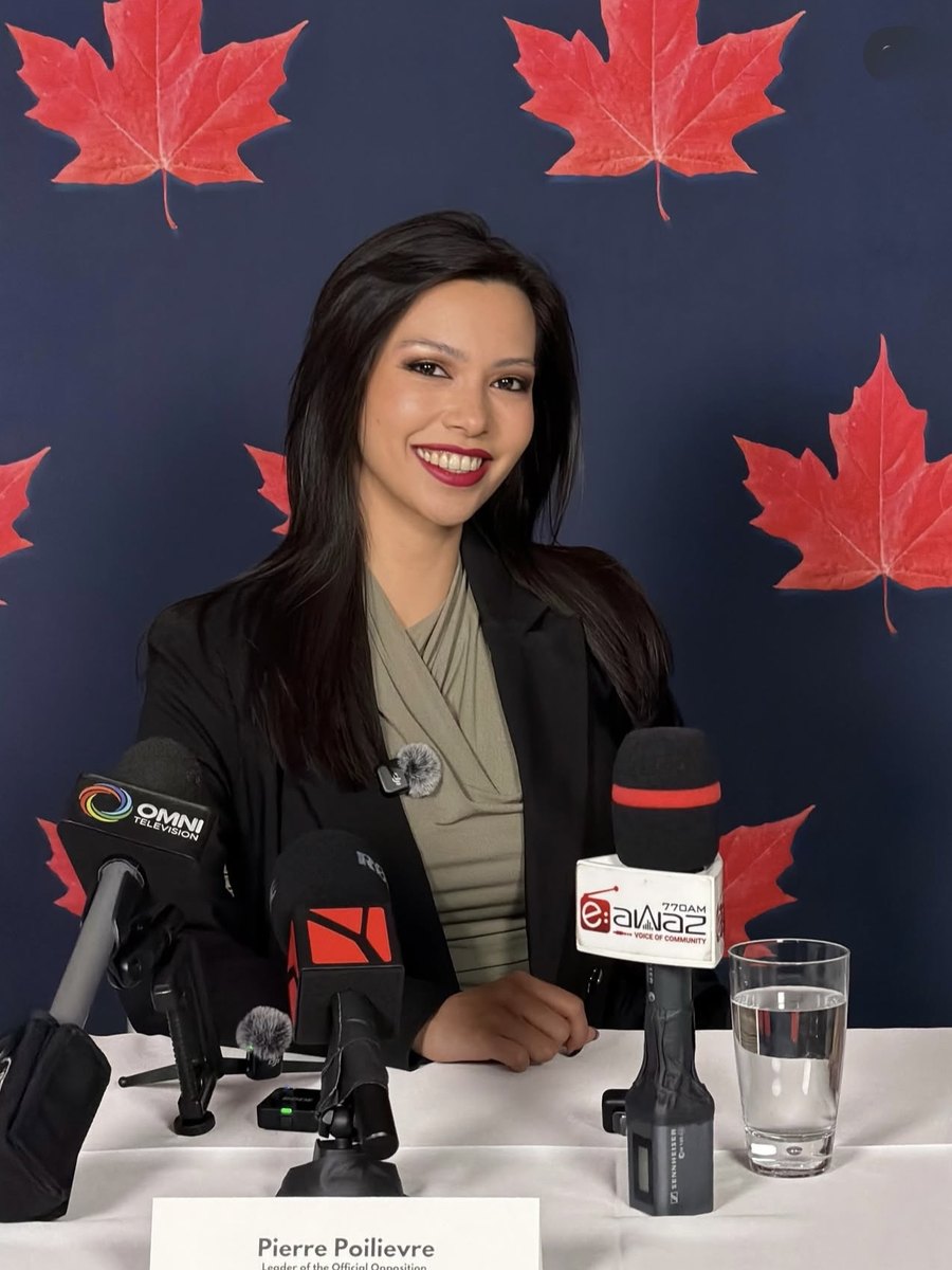 Rachel Dragas seated with press microphones at Pierre Poilievre's 2026 press conference